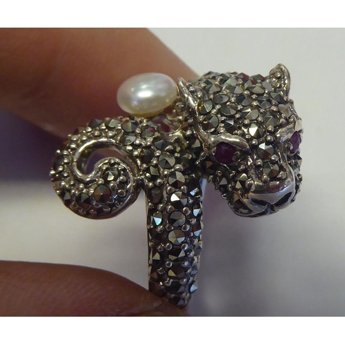 285 - A silver coloured metal and marcasite Panther style ring with ruby set eyes