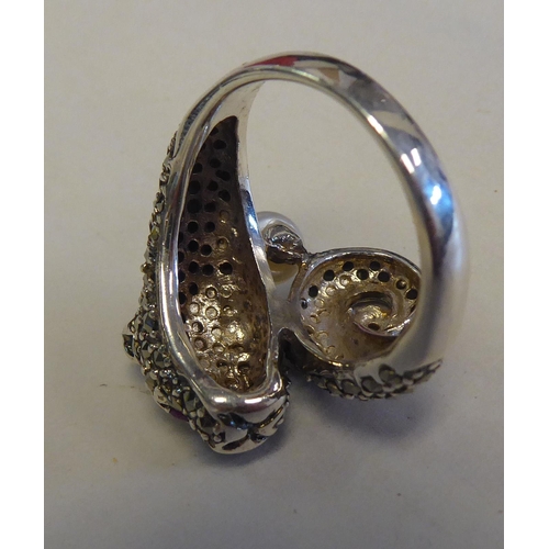 285 - A silver coloured metal and marcasite Panther style ring with ruby set eyes