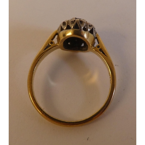 290 - An 18ct gold ring, set with a dark blue stone, surrounded by white stones