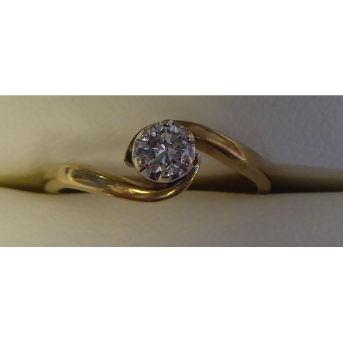 295 - A 14ct gold, crossover set, single stone diamond ring