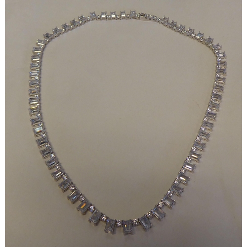 299 - An Art Deco inspired silver coloured metal and cubic zirconia set, box link necklace