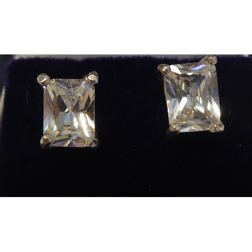 305 - A pair of silver coloured metal and cubic zirconia set stud earrings