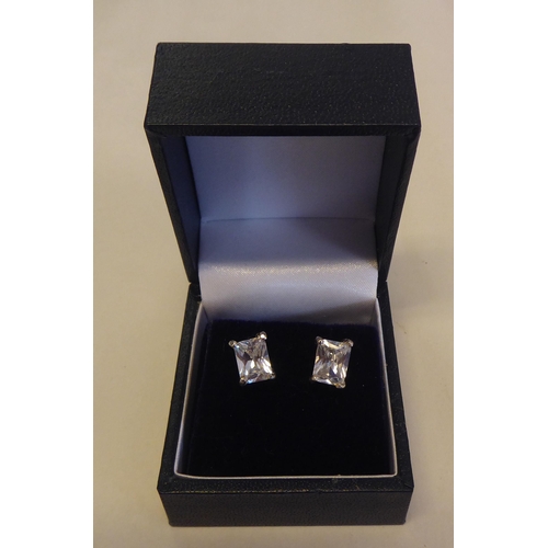 305 - A pair of silver coloured metal and cubic zirconia set stud earrings