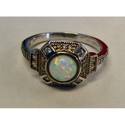 314 - A silver coloured metal, cubic zirconia and opal set ring