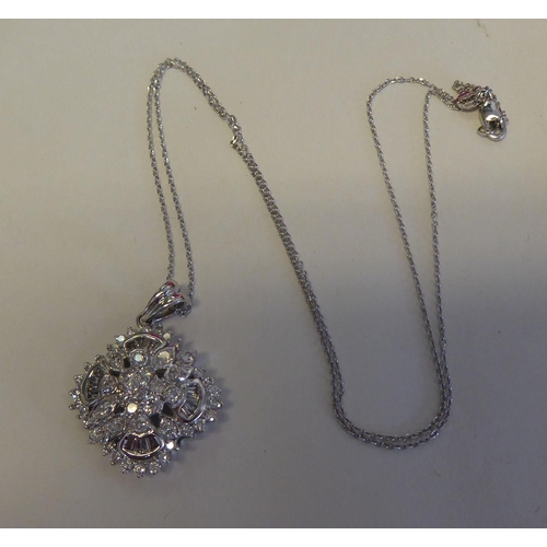 320 - A 14ct white gold and diamond set pendant, on a fine neckchain