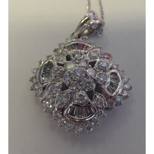 320 - A 14ct white gold and diamond set pendant, on a fine neckchain