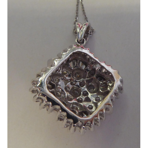 320 - A 14ct white gold and diamond set pendant, on a fine neckchain