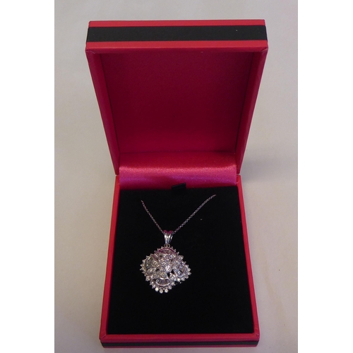 320 - A 14ct white gold and diamond set pendant, on a fine neckchain