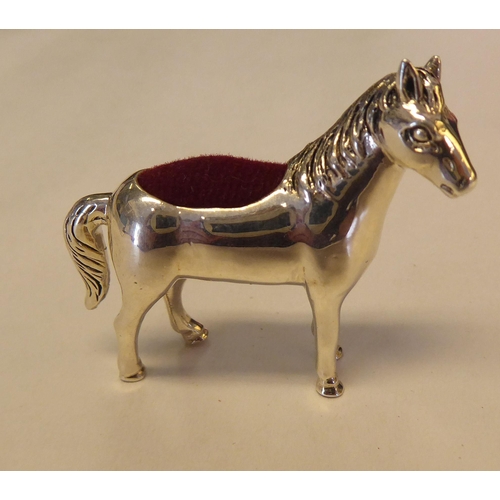 324 - A silver coloured metal novelty pin cushion, fashioned as a standing pony