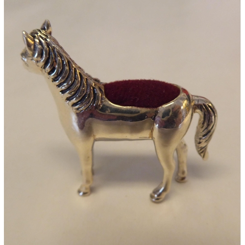 324 - A silver coloured metal novelty pin cushion, fashioned as a standing pony