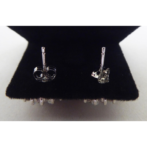 337 - A pair of silver coloured metal, cubic zirconia and opal set earrings