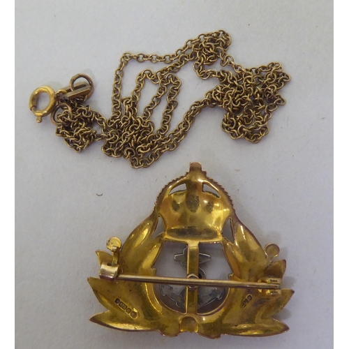 361 - A 9ct gold naval themed brooch; and a fine 9ct gold chain 