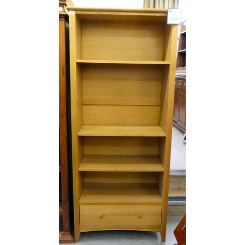 393 - A modern light oak bookcase with four shelves and a drawer, on a plinth  74