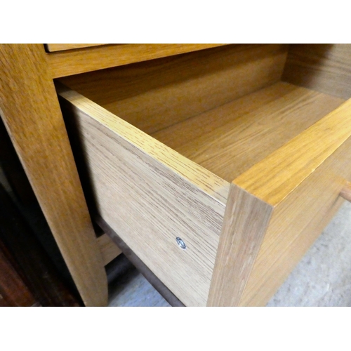 393 - A modern light oak bookcase with four shelves and a drawer, on a plinth  74