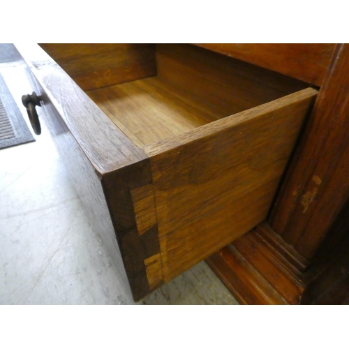 396 - A modern teak bookcase with three shelves and two drawers, on a plinth  76