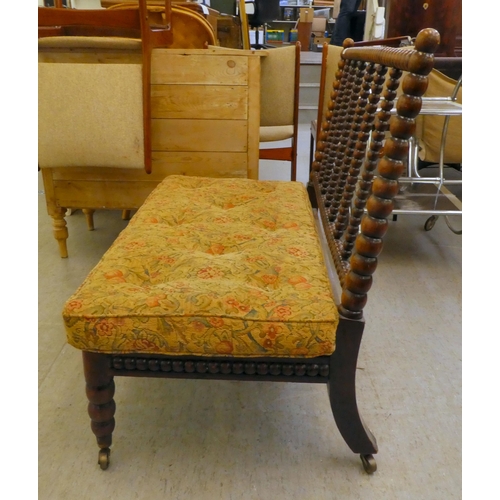 397 - A late Victorian faux rosewood framed bobbin turned salon settee, raised on casters 