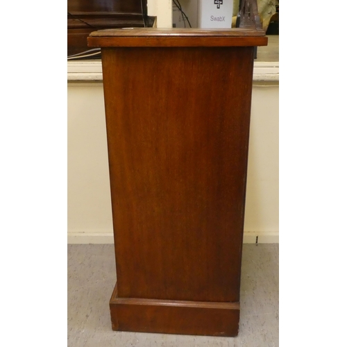 398 - A late Victorian walnut pot cupboard with a door, on a plinth  29