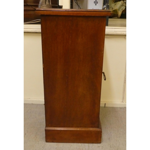 398 - A late Victorian walnut pot cupboard with a door, on a plinth  29