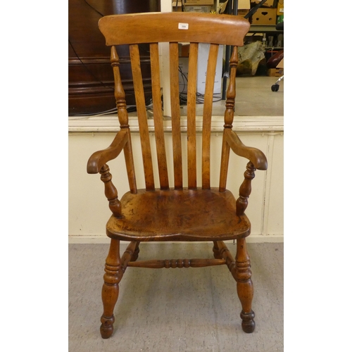 399 - A late Victorian elm and beech framed grandfather chair with a slatted back and solid seat, raised o... 