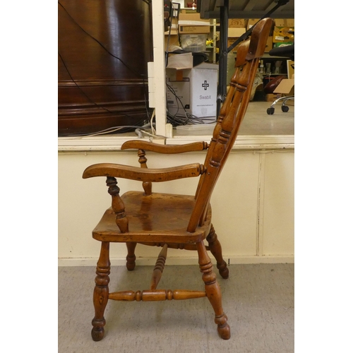 399 - A late Victorian elm and beech framed grandfather chair with a slatted back and solid seat, raised o... 