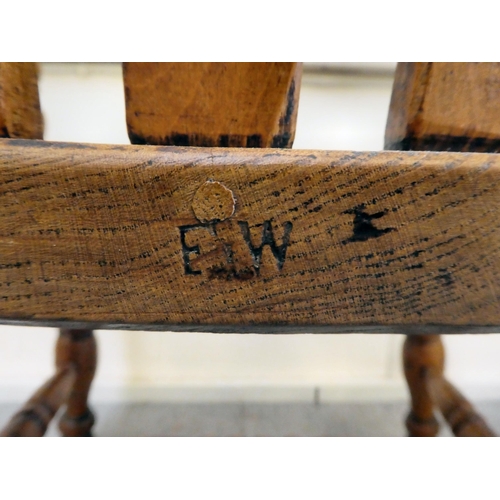 399 - A late Victorian elm and beech framed grandfather chair with a slatted back and solid seat, raised o... 