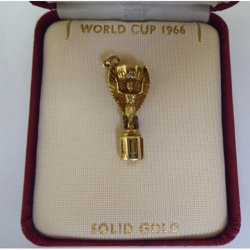 406 - A 9ct gold charm, fashioned as the 1966 World Cup  boxed 