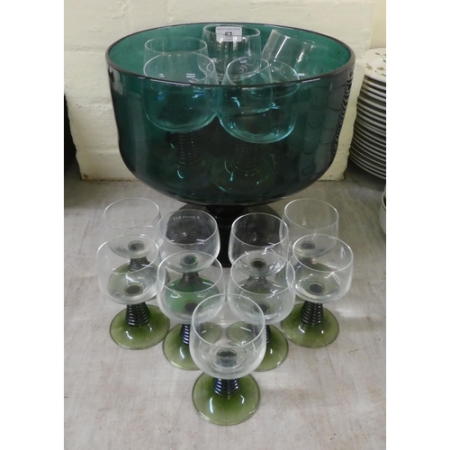 62 - Glassware: to include a green glass pedestal punch bowl with six pedestal glasses