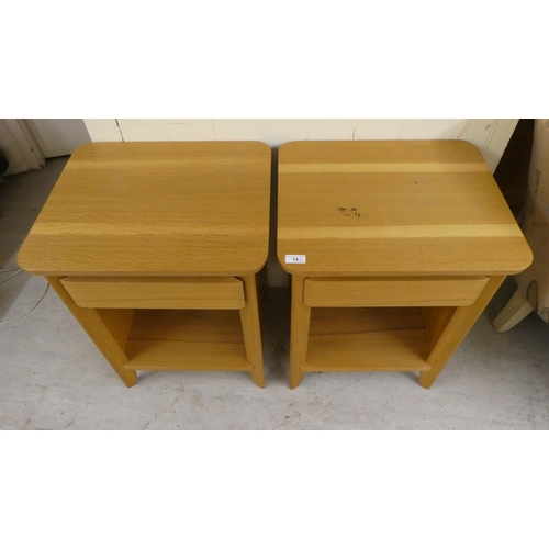 74 - A pair of modern light oak bedside chests with a single drawer, over an open shelf, raised on straig... 