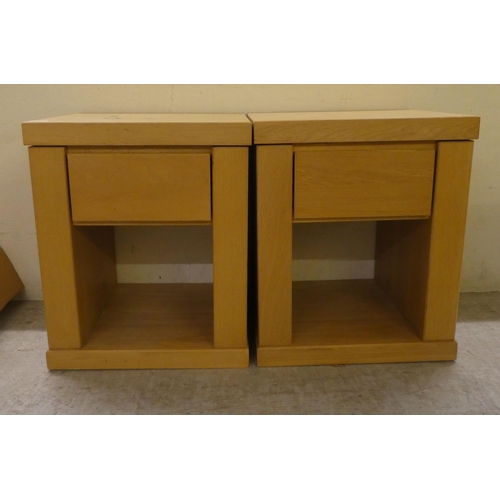 75 - A pair of John Lewis light oak single drawer bedside chests, on a plinth  24