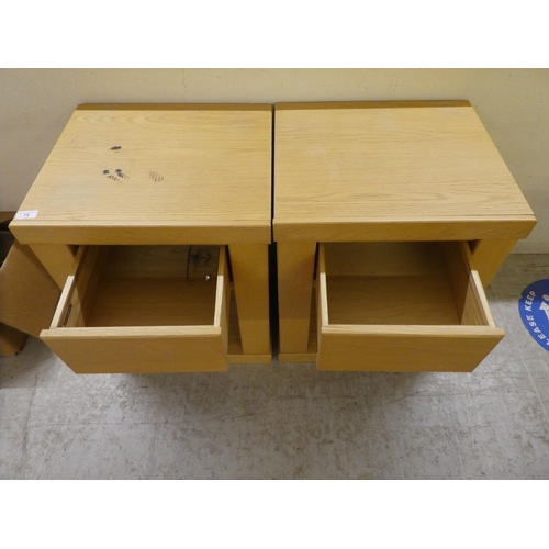 75 - A pair of John Lewis light oak single drawer bedside chests, on a plinth  24