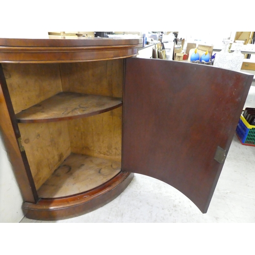 76 - A late Victorian mahogany corner cabinet with a panelled door, on a plinth  40