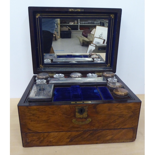 272 - A late Victorian walnut vanity box with straight sides and a hinged lid, enclosing a fitted interior... 