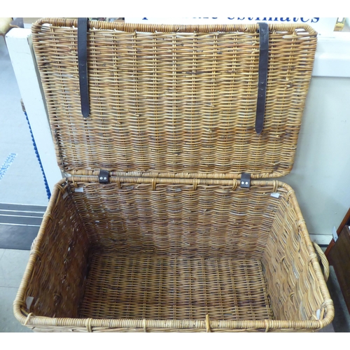 376 - A wicker hamper with hide straps and a hinged lid  22