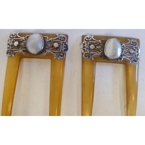 103 - Two vintage amber coloured hair grips, each set with a pearl