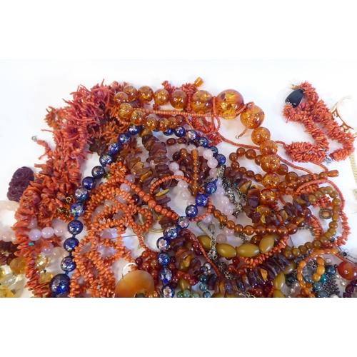 116 - Coral and amber coloured and other costume jewellery 