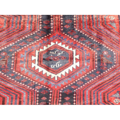 147 - A Persian Hamadan rug, decorated with geometric designs and birds, on a blue ground  96