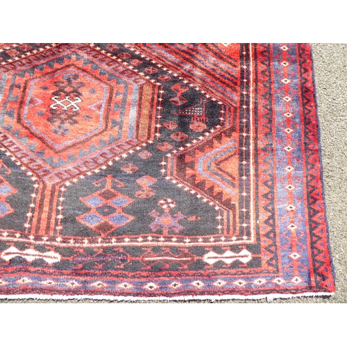 147 - A Persian Hamadan rug, decorated with geometric designs and birds, on a blue ground  96