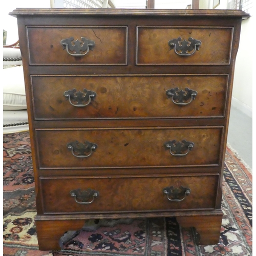 15 - A modern Georgian design mahogany and burr walnut, five drawer dressing chest, raised on bracket fee... 