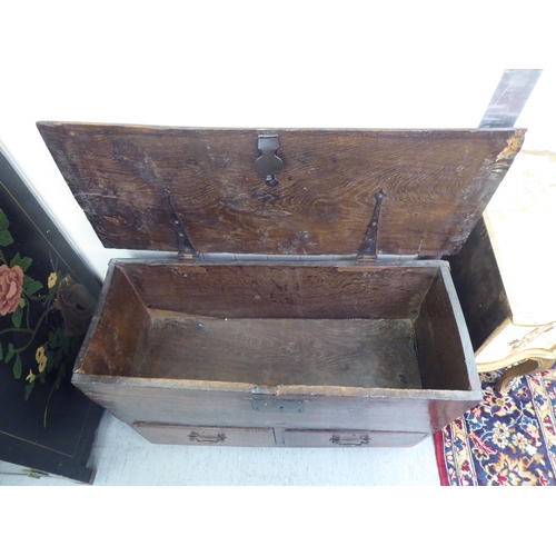 17 - A mid 18thC oak mule chest with two base drawers  24