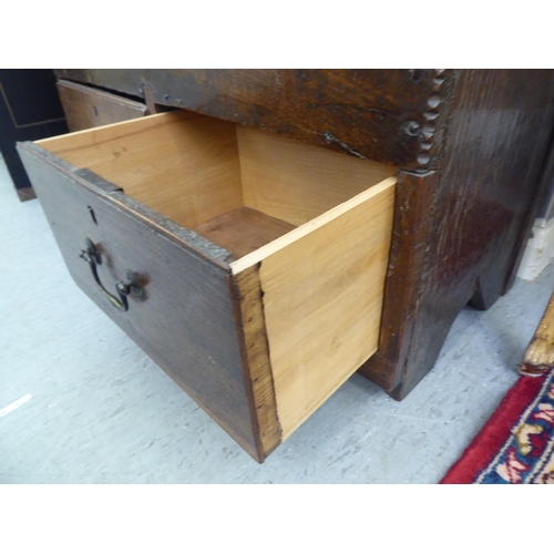 17 - A mid 18thC oak mule chest with two base drawers  24