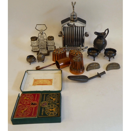 184 - Early 20thC and later collectables: to include small copper jelly moulds; a silver plated table crue... 