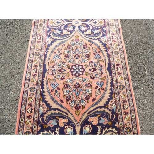 191 - A Persian Kashan runner, decorated with floral patterns, on a pink ground&nbsp; 232