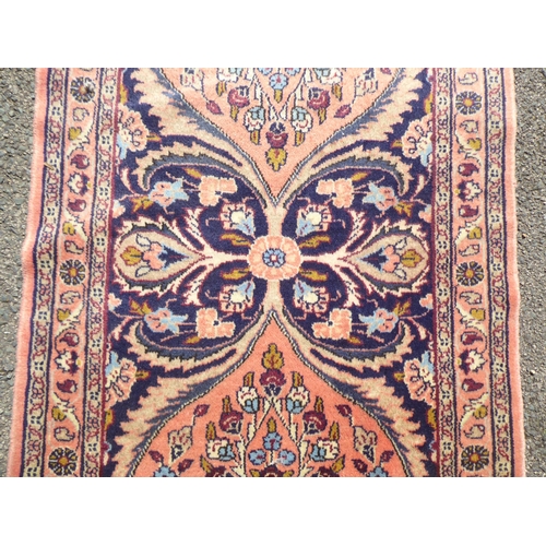 191 - A Persian Kashan runner, decorated with floral patterns, on a pink ground&nbsp; 232