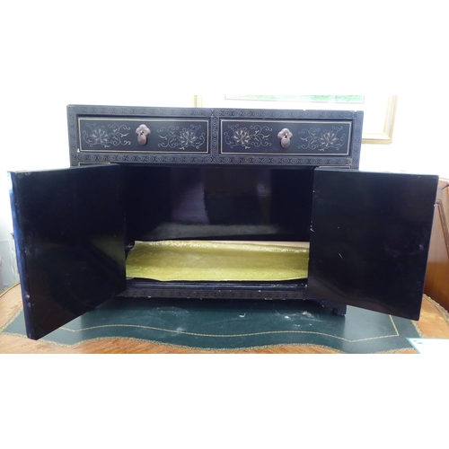 20 - A modern Chinese black lacquered and overpainted table-top cabinet with two drawers, over two panell... 