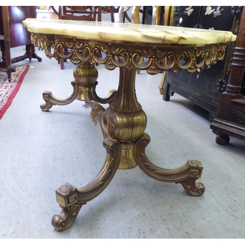 22 - A modern onyx top coffee table, raised on a splayed brass frame  19