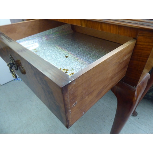 25 - A 1930s walnut two drawer side table, raised on cabriole legs  31.5