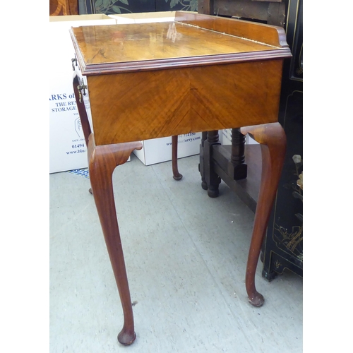 25 - A 1930s walnut two drawer side table, raised on cabriole legs  31.5