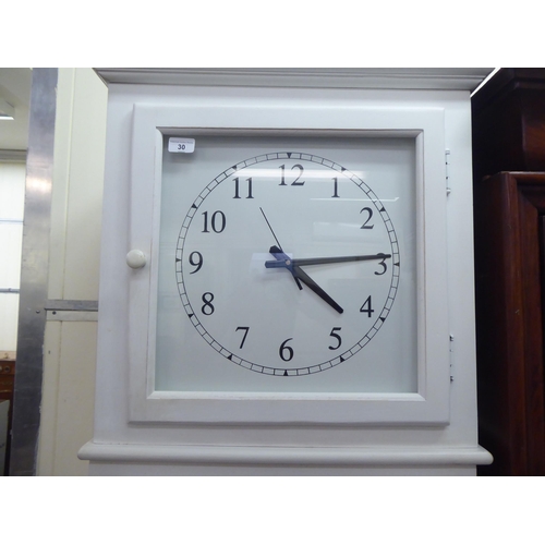 30 - A modern white painted cabinet, fashioned as a longcase clock with two doors, raised on square, tape... 