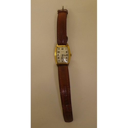 350 - A Nivada gold plated cased wristwatch, faced by an Arabic dial with subsidiary seconds, on a brown h... 