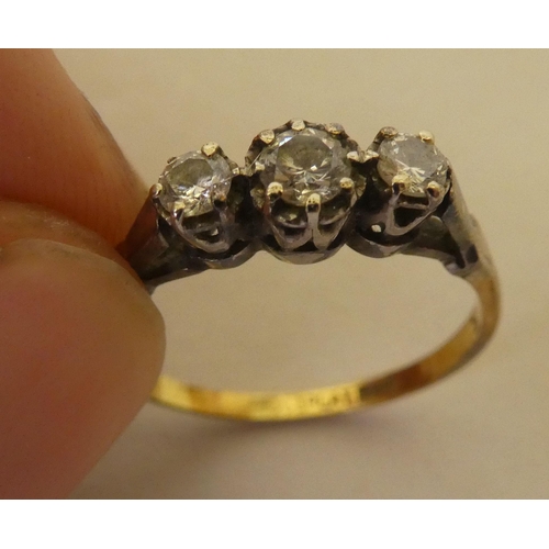 362 - A bi-coloured metal ring  stamped 'Plat', set with three white stones